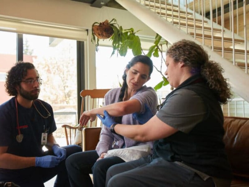 Woman with injured arm receiving care in the comfort of her own home.