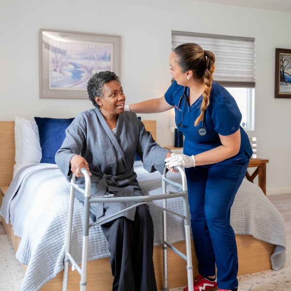 Provider using an iPad to explain her care in her living room