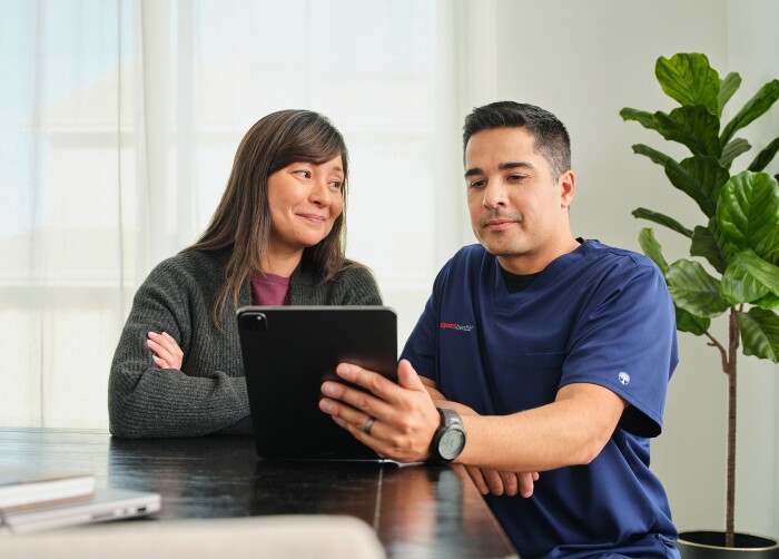 DispatchHealth Provider working with a patient on an iPad